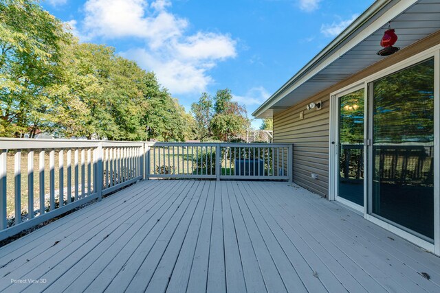 wooden terrace with a yard