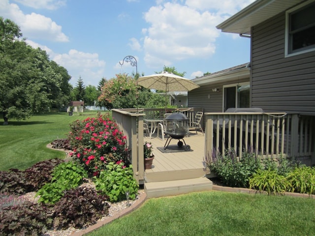 wooden terrace with outdoor dining area and a yard