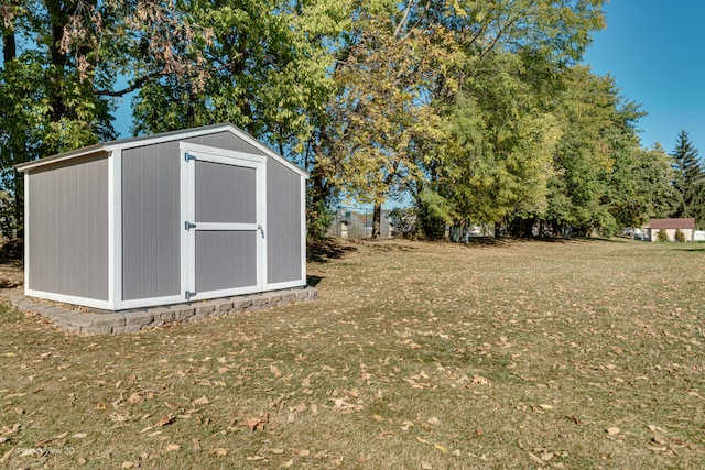 view of outbuilding featuring a lawn