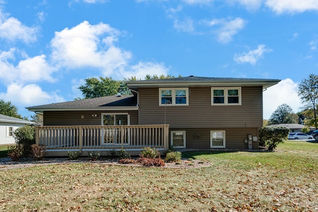 back of house featuring a yard and a wooden deck