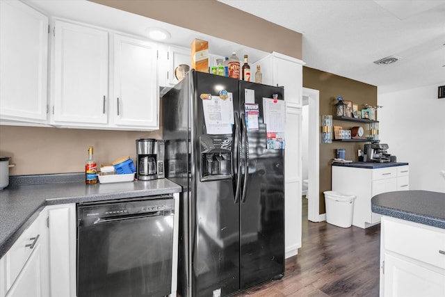 kitchen with dark wood-type flooring, black appliances, and white cabinets