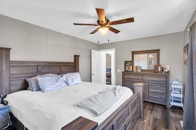 bedroom featuring ceiling fan, a textured ceiling, and dark hardwood / wood-style floors