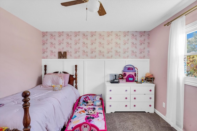 bedroom featuring a textured ceiling, carpet floors, and ceiling fan