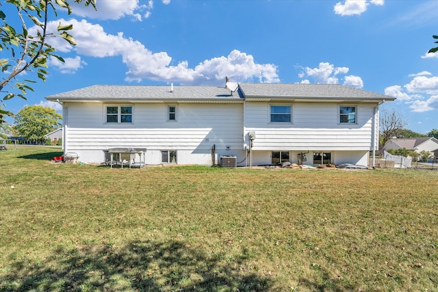 back of house featuring a lawn and central AC unit