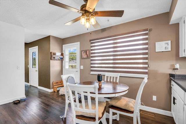 dining room with ceiling fan, a textured ceiling, and dark hardwood / wood-style flooring