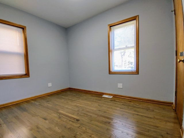 unfurnished room featuring hardwood / wood-style flooring