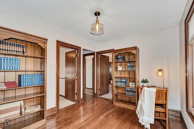 office area featuring baseboards and wood finished floors