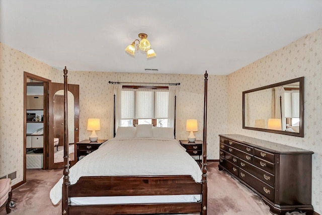 bedroom featuring visible vents, baseboards, light colored carpet, and wallpapered walls