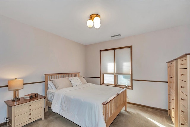 bedroom with visible vents, baseboards, and light colored carpet