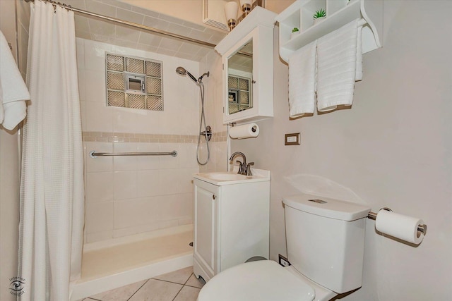 bathroom with tile patterned flooring, a shower stall, toilet, and a sink