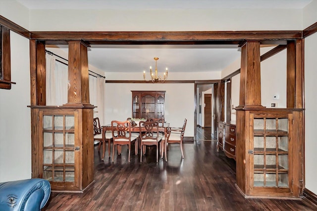 dining space with dark wood-type flooring and an inviting chandelier