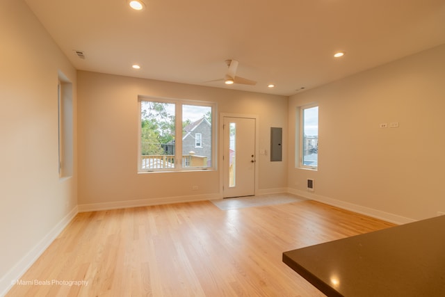 entryway featuring electric panel, light hardwood / wood-style flooring, and ceiling fan