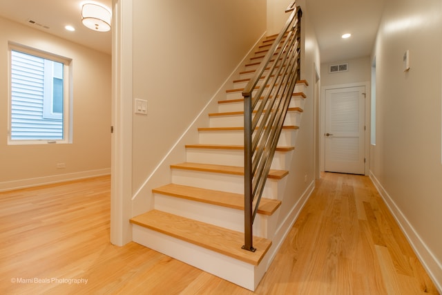 stairway with hardwood / wood-style flooring