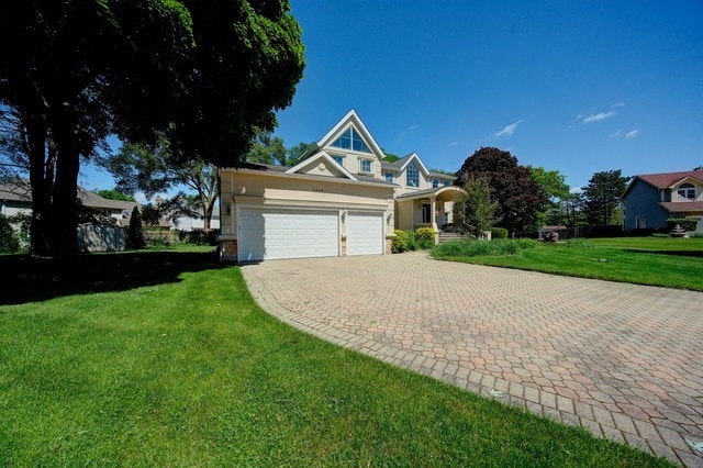 view of front of home featuring a front lawn and a garage