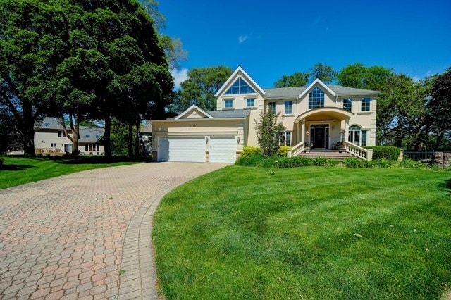 view of front of house featuring a front lawn and a garage