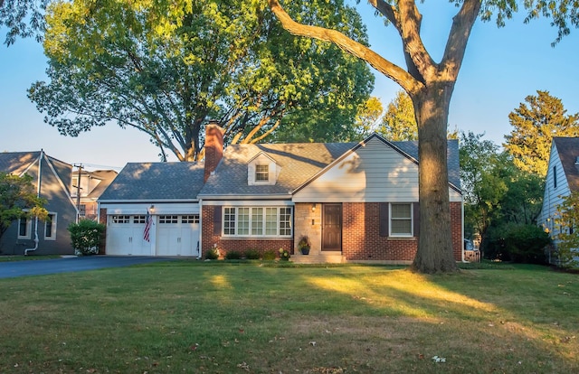 view of front of home with a garage and a front lawn