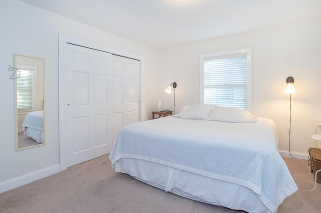 carpeted bedroom featuring a closet