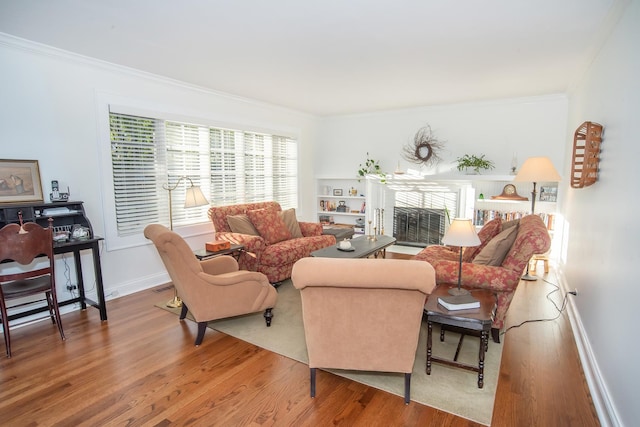 living room with ornamental molding and hardwood / wood-style floors