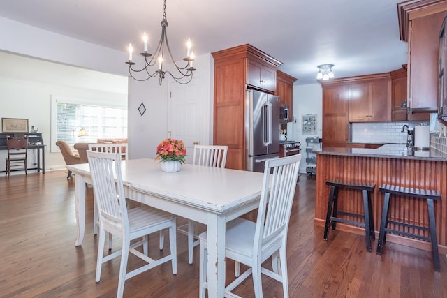 dining area featuring dark hardwood / wood-style floors and a chandelier