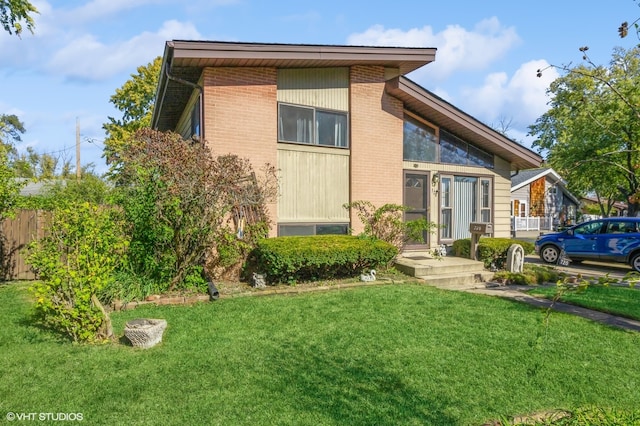 back of house with a lawn