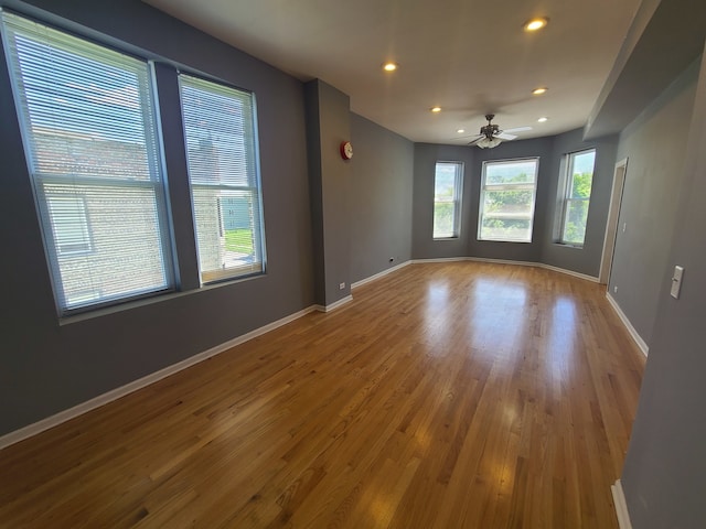 empty room with ceiling fan and hardwood / wood-style flooring