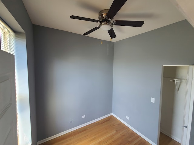 unfurnished bedroom featuring light hardwood / wood-style flooring, a closet, and ceiling fan