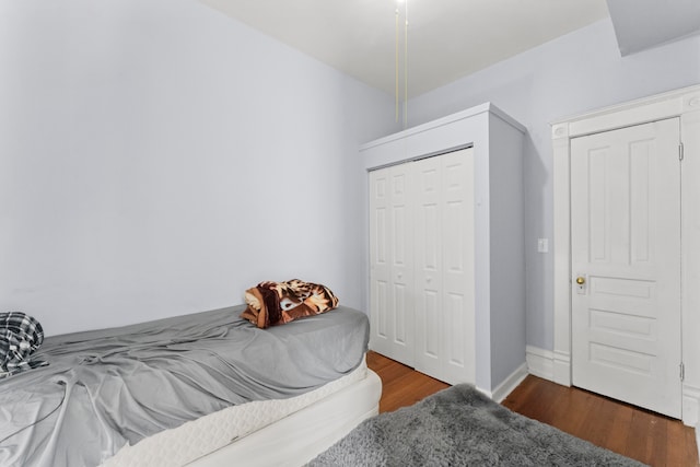 bedroom with a closet and dark hardwood / wood-style flooring