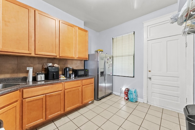 kitchen with backsplash, stainless steel fridge with ice dispenser, and light tile patterned floors