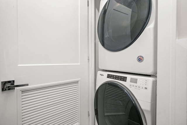 laundry room with stacked washer / drying machine