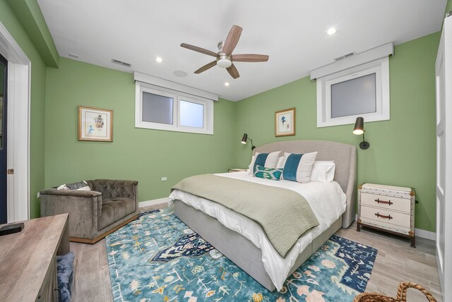 bedroom with light hardwood / wood-style flooring and ceiling fan