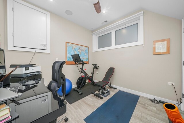 workout room with light hardwood / wood-style flooring and ceiling fan