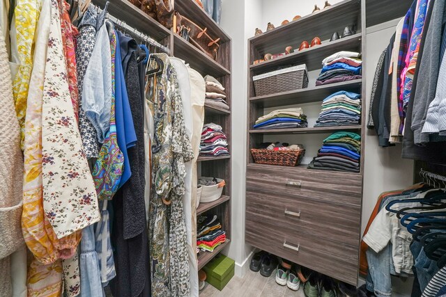 spacious closet with light hardwood / wood-style flooring