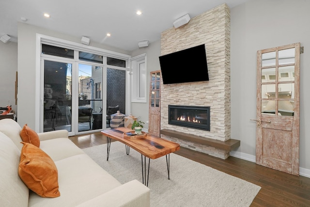 living room featuring dark hardwood / wood-style flooring and a fireplace