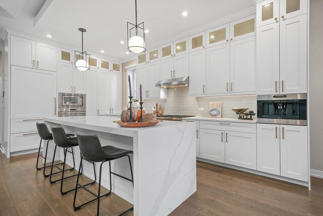 kitchen featuring a center island with sink, appliances with stainless steel finishes, and white cabinets