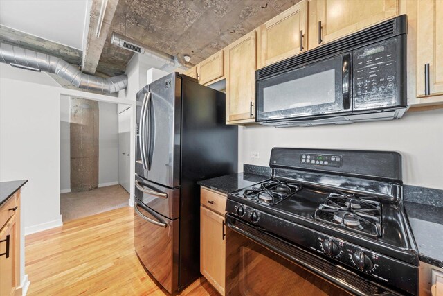 kitchen featuring light wood-type flooring, light brown cabinetry, and black appliances