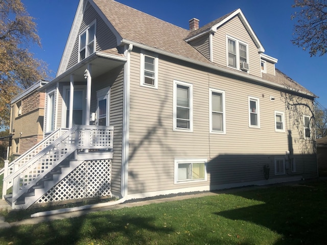 rear view of house featuring a yard