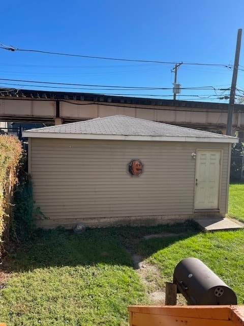 view of outbuilding with a lawn