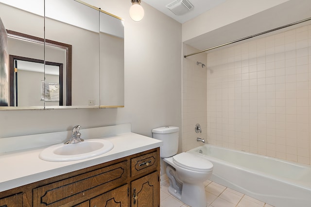 full bathroom with vanity, tiled shower / bath combo, toilet, and tile patterned floors