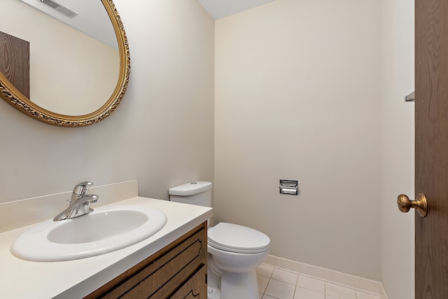 bathroom with vanity, toilet, and tile patterned floors