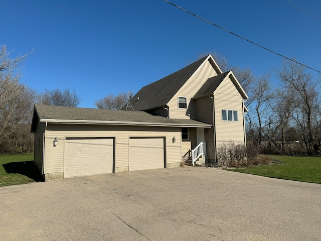 exterior space featuring a yard and a garage