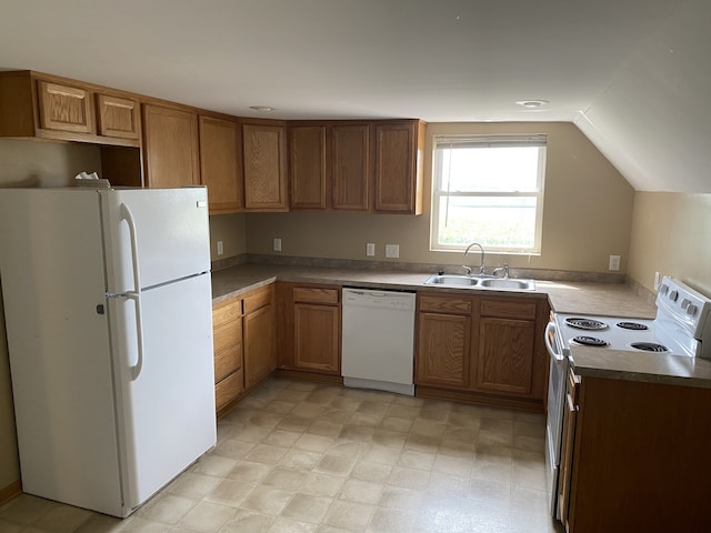 kitchen featuring white appliances, lofted ceiling, and sink