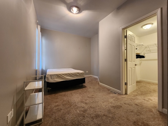 bedroom featuring a closet, carpet floors, and a spacious closet