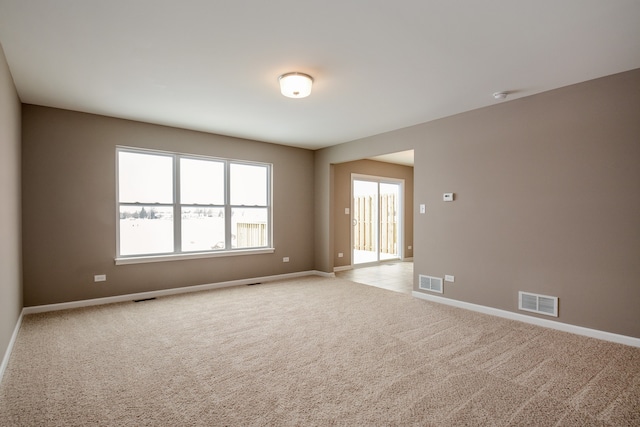 spare room featuring light colored carpet