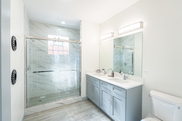 bathroom featuring toilet, an enclosed shower, and vanity