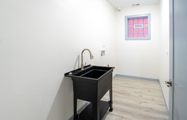 laundry area with washer hookup and light wood-type flooring