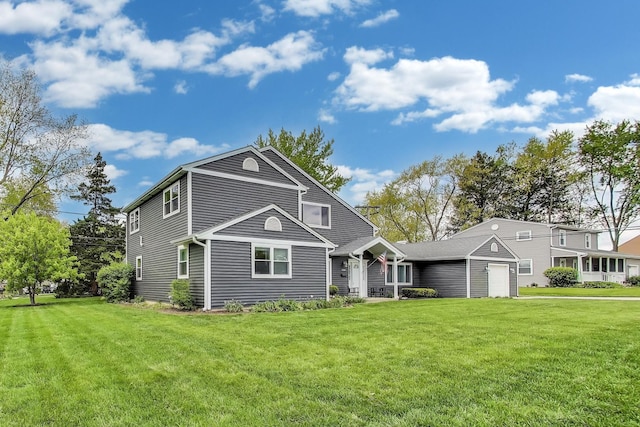 view of front of home with a front yard and a garage