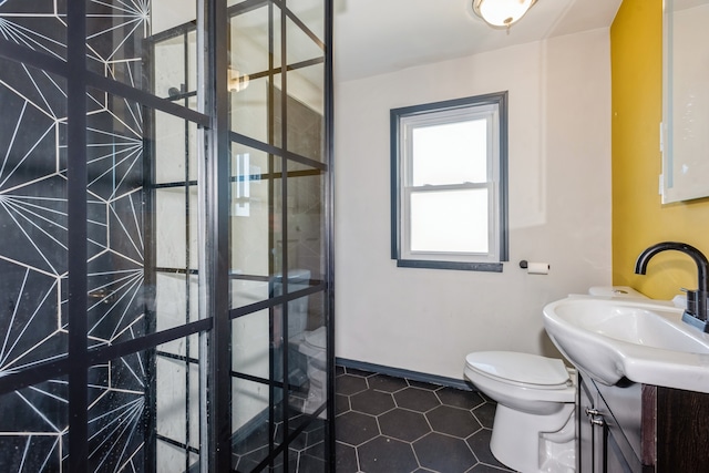 bathroom featuring vanity, toilet, and tile patterned flooring