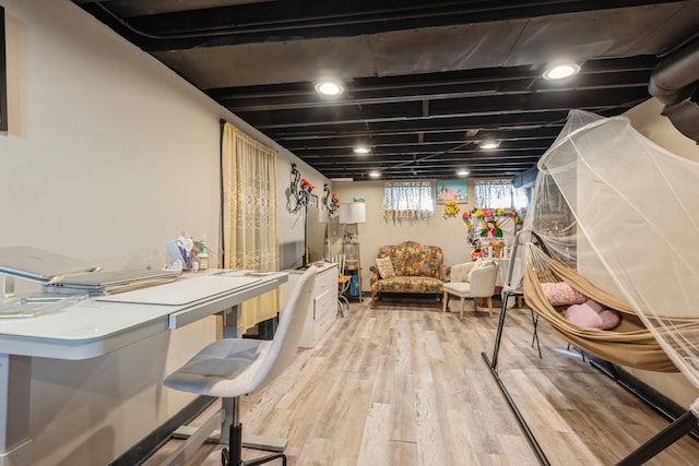 basement with light hardwood / wood-style flooring