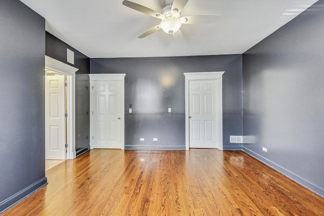 empty room with light wood-type flooring and ceiling fan