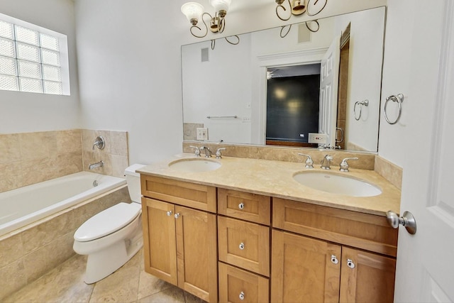 bathroom featuring vanity, tiled tub, toilet, and tile patterned floors